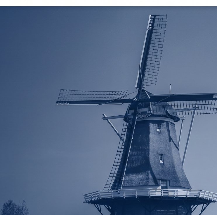 Traditional Dutch windmill against a pale sky